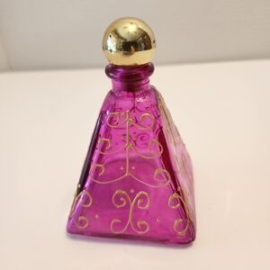 Pink Pyramid Shaped Glass Bottle With Gold Round Cork Stopper Swirls Are Raised